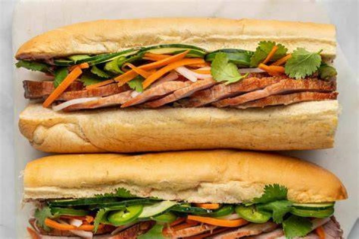 Banh mi toppings Crossword Clue